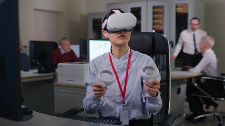 Young woman in formal wear use vr headset and joysticks in modern office. Industrial designer or engineer work in augmented goggles
