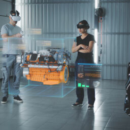 Two service manager engineers use virtual reality technology to diagnose an eco-friendly car engine with an augmented reality interface and 3D engine visualization