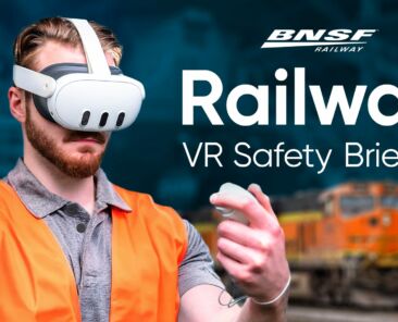 A rail maintenance worker wearing an orange safety vest and Meta Quest 3 headset interacts with a VR controller, with a BNSF locomotive visible in the background